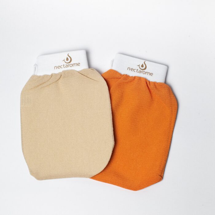 Two exfoliating gloves are displayed side by side on a white background. The glove on the left is beige, and the glove on the right is orange. Both gloves have a white cuff at the top with the brand name "nectarome" printed in brown. Best gloves for skin care.