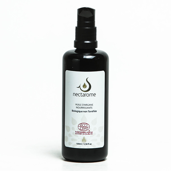 A black bottle of Nectarome "Huile d'Argane Nourrissante" (organic argan oil) is shown against a white background. The label highlights that this 100ml (3.38 fl oz) nourishing oil is certified organic and non-toasted, emphasizing the purity and natural benefits of organic argan oil for skin and hair care.